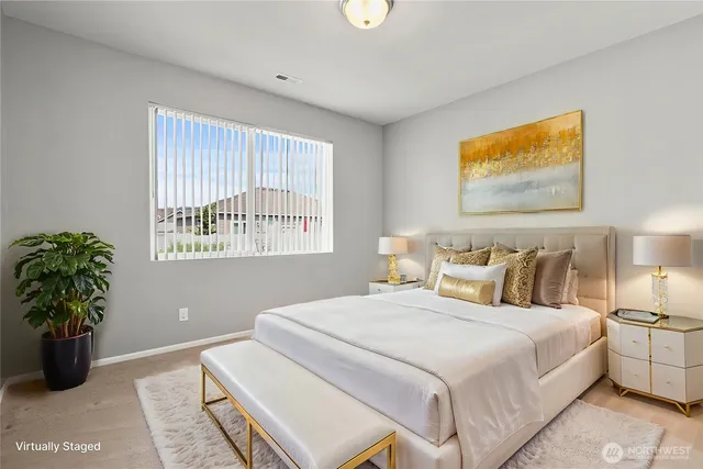 a bedroom with bed and a potted plant