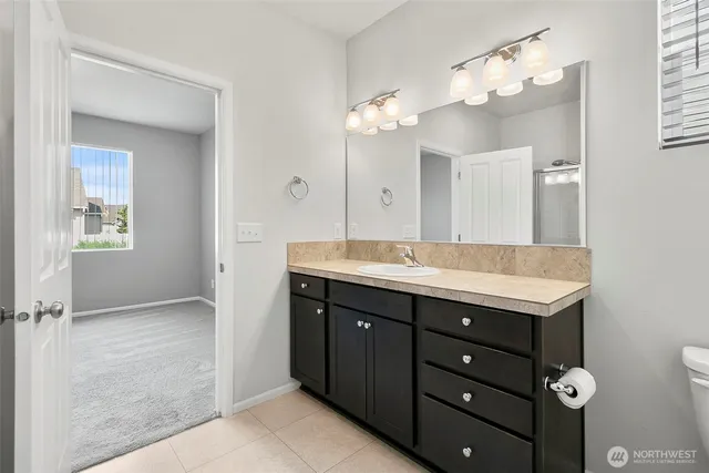 a bathroom with a double vanity sink and a mirror