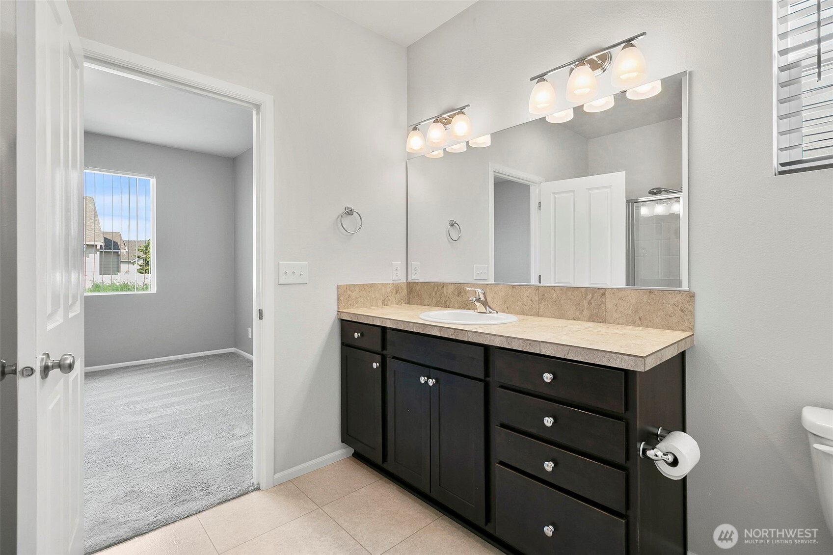 103 Hickory Avenue Southwest, Unit 35 Orting, WA 98360 - Photo 18 of 38 a bathroom with a double vanity sink and a mirror
