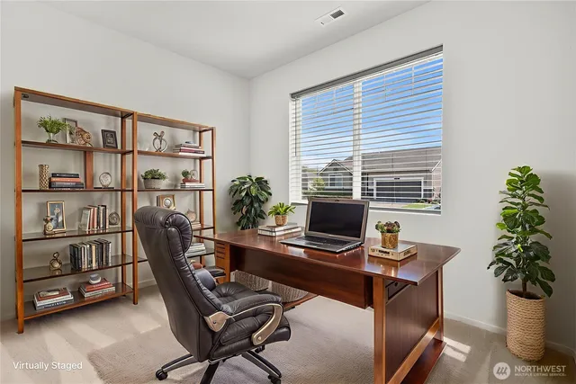 a view of a workspace with furniture and a potted plant