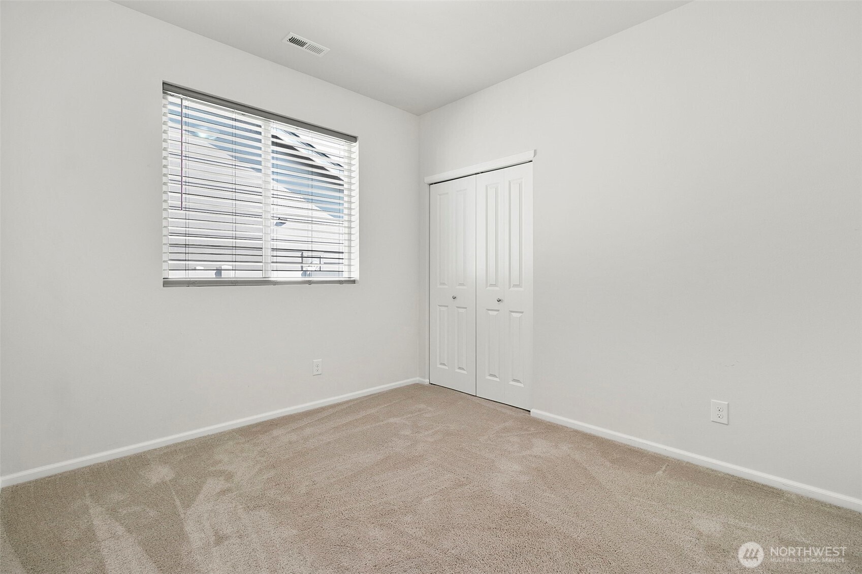 103 Hickory Avenue Southwest, Unit 35 Orting, WA 98360 - Photo 21 of 38 a view of an empty room with a window