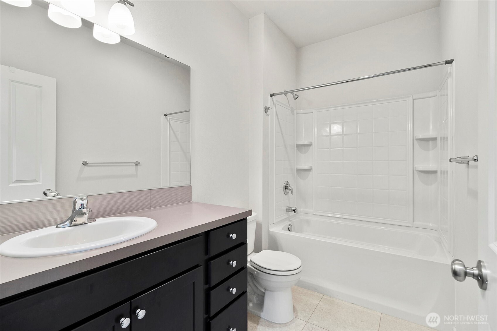 103 Hickory Avenue Southwest, Unit 35 Orting, WA 98360 - Photo 22 of 38 a bathroom with a sink a toilet and shower