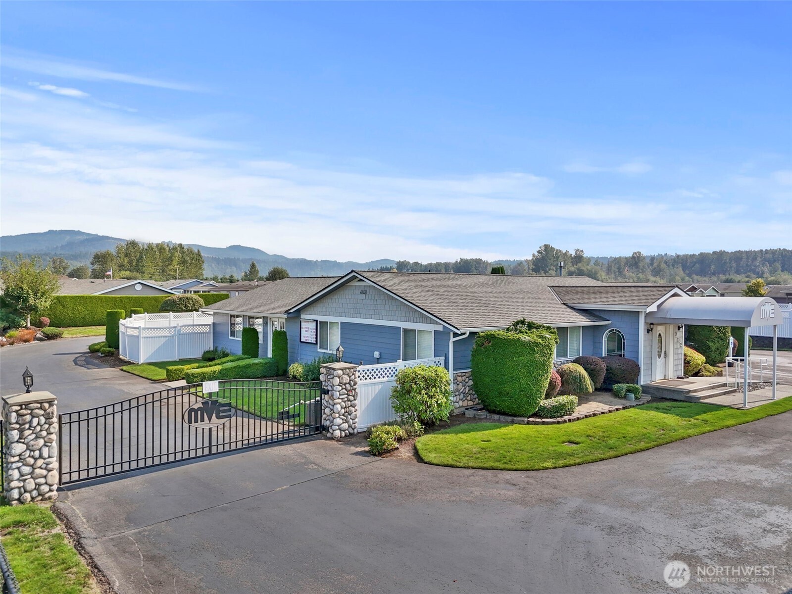 103 Hickory Avenue Southwest, Unit 35 Orting, WA 98360 - Photo 29 of 38 a view of a house with a big yard and potted plants