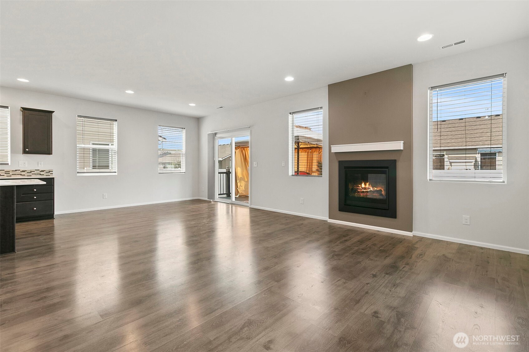 103 Hickory Avenue Southwest, Unit 35 Orting, WA 98360 - Photo 3 of 38 an empty room with wooden floor fireplace and windows