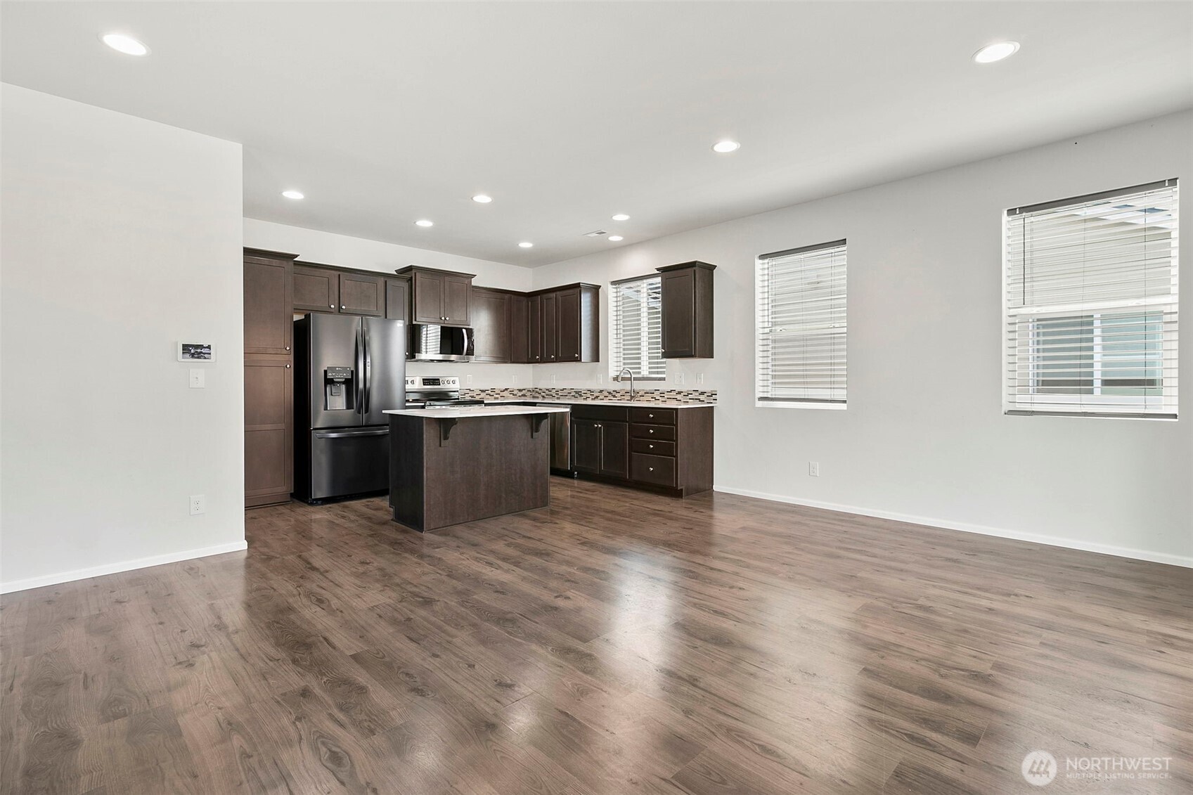 103 Hickory Avenue Southwest, Unit 35 Orting, WA 98360 - Photo 7 of 38 a view of kitchen with wooden floor and electronic appliances