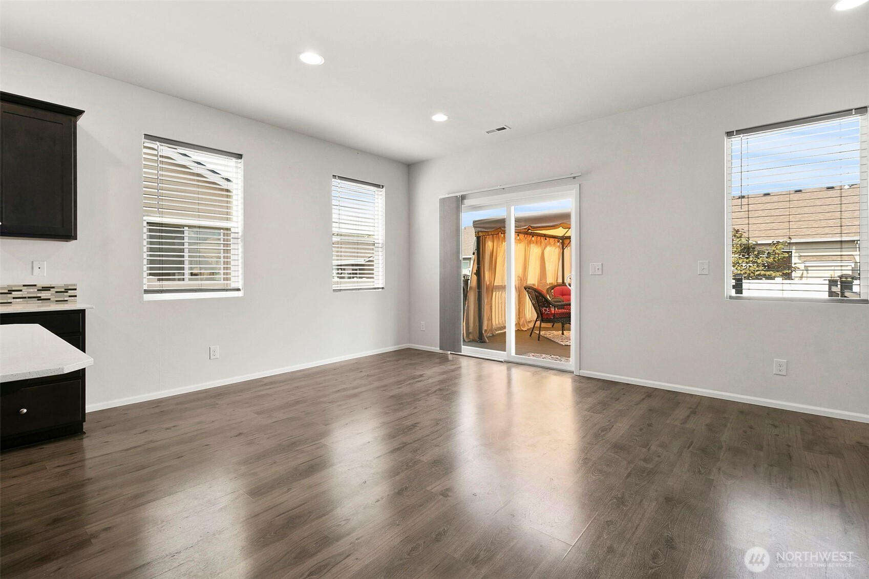 103 Hickory Avenue Southwest, Unit 35 Orting, WA 98360 - Photo 8 of 38 a view of an empty room with wooden floor and a window