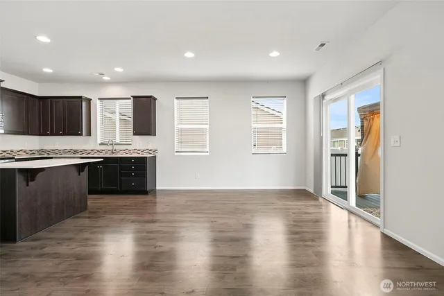 a large kitchen with stainless steel appliances granite countertop a large counter top and a stove top oven