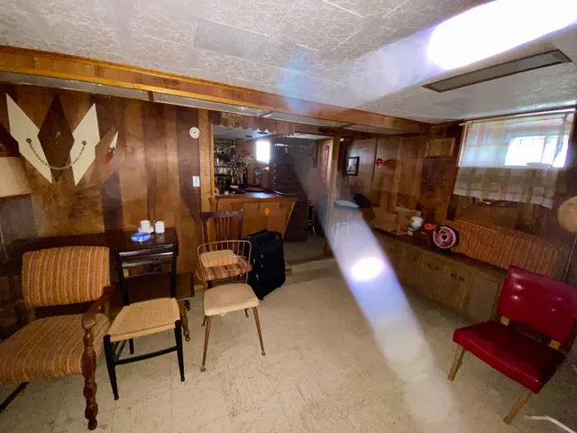 a living room with furniture and a lamp