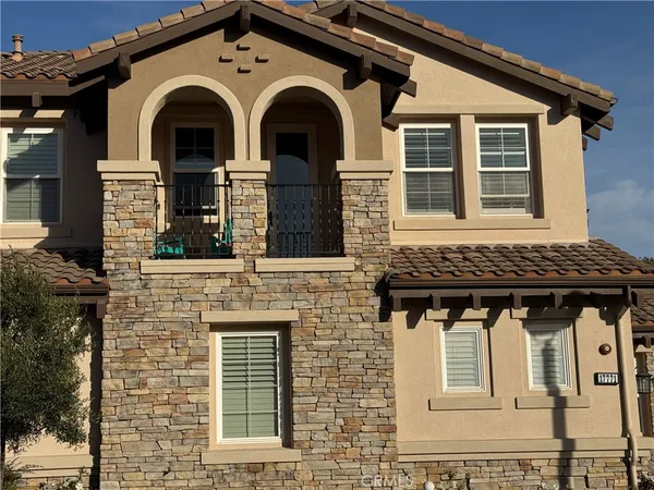a front view of a house with large windows