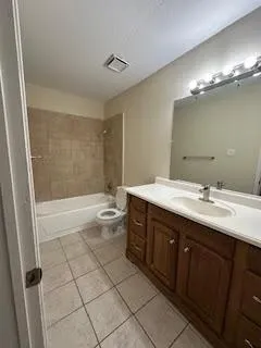 a bathroom with a double vanity sink mirror and toilet