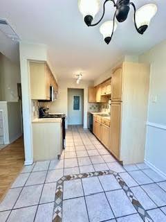 2240 Tarpley Road, Unit 433 Carrollton, TX 75006 - Photo 6 of 14 a kitchen with stainless steel appliances granite countertop a refrigerator a sink dishwasher and a stove top oven