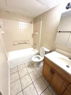 2240 Tarpley Road, Unit 433 Carrollton, TX 75006 - Photo 9 of 14 a bathroom with a granite countertop sink a toilet a mirror and bathtub