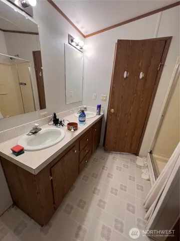 a bathroom with a sink vanity and mirror