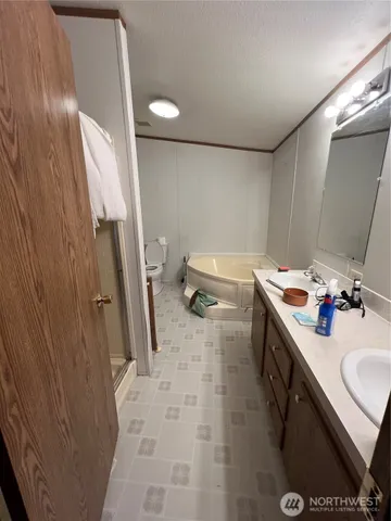 a bathroom with a sink a toilet and a mirror