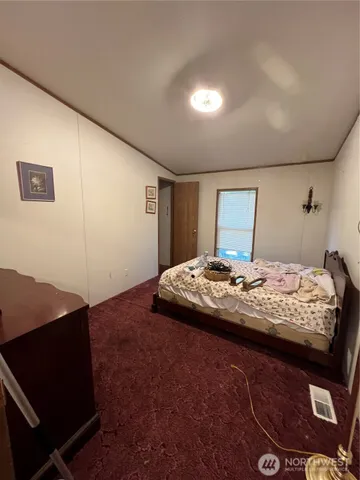 a bedroom with a bed and a night stand