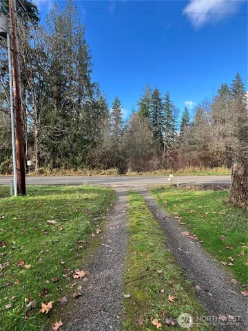 a view of outdoor space with green field and trees all around