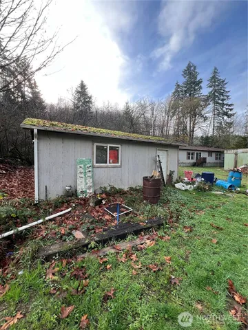 a backyard of a house with table and chairs