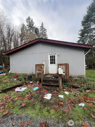 a backyard of a house with table and chairs