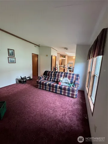 a bed room with furniture and a flat screen tv