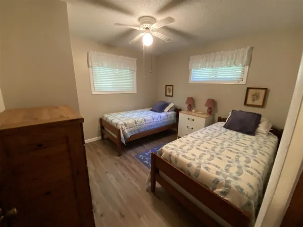 a bedroom with two beds and a chandelier
