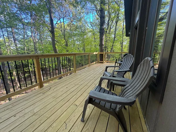 a view of balcony with wooden floor and outdoor seating