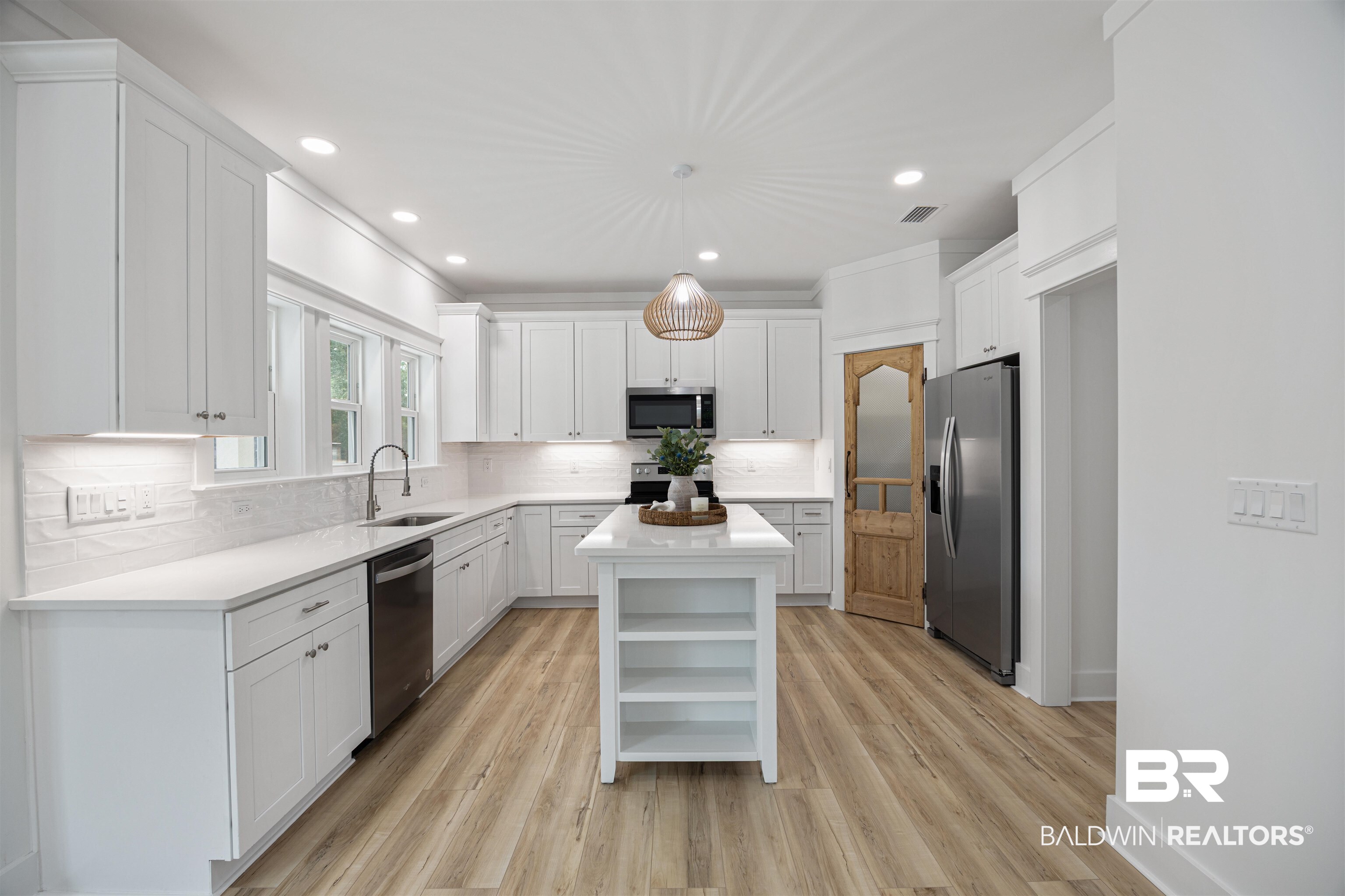 27591 Canal Road Orange Beach, AL 36561 - Photo 15 of 51 Kitchen with open shelves, a center island, white cabinets, backsplash, and recessed lighting