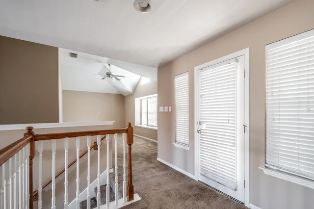 a view of a hallway with windows