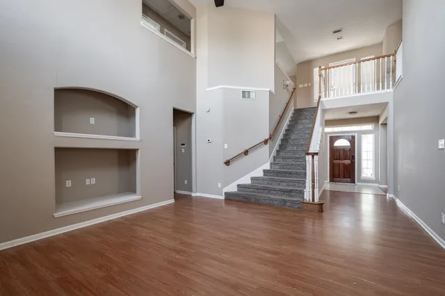a view of entryway and hall with wooden floor