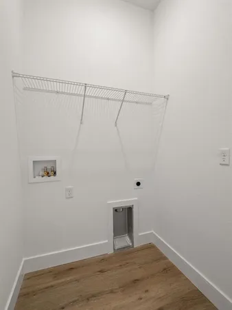 a view of a room with wooden floor