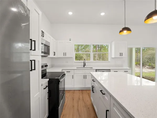 a kitchen with a sink stove and cabinets