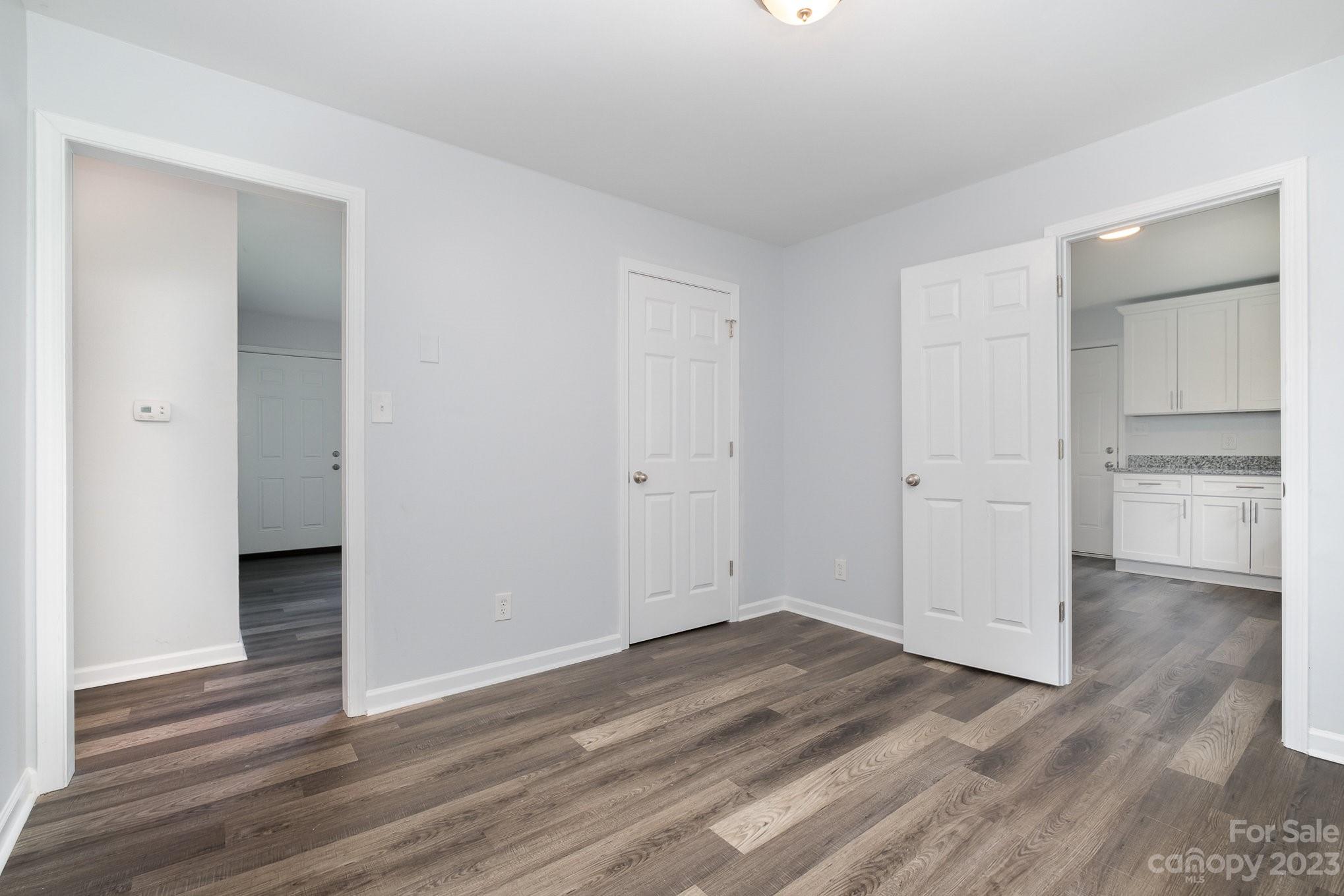 6364 Monteith Drive Charlotte, NC 28213 - Photo 12 of 35 a view of an empty room with wooden floor and a window