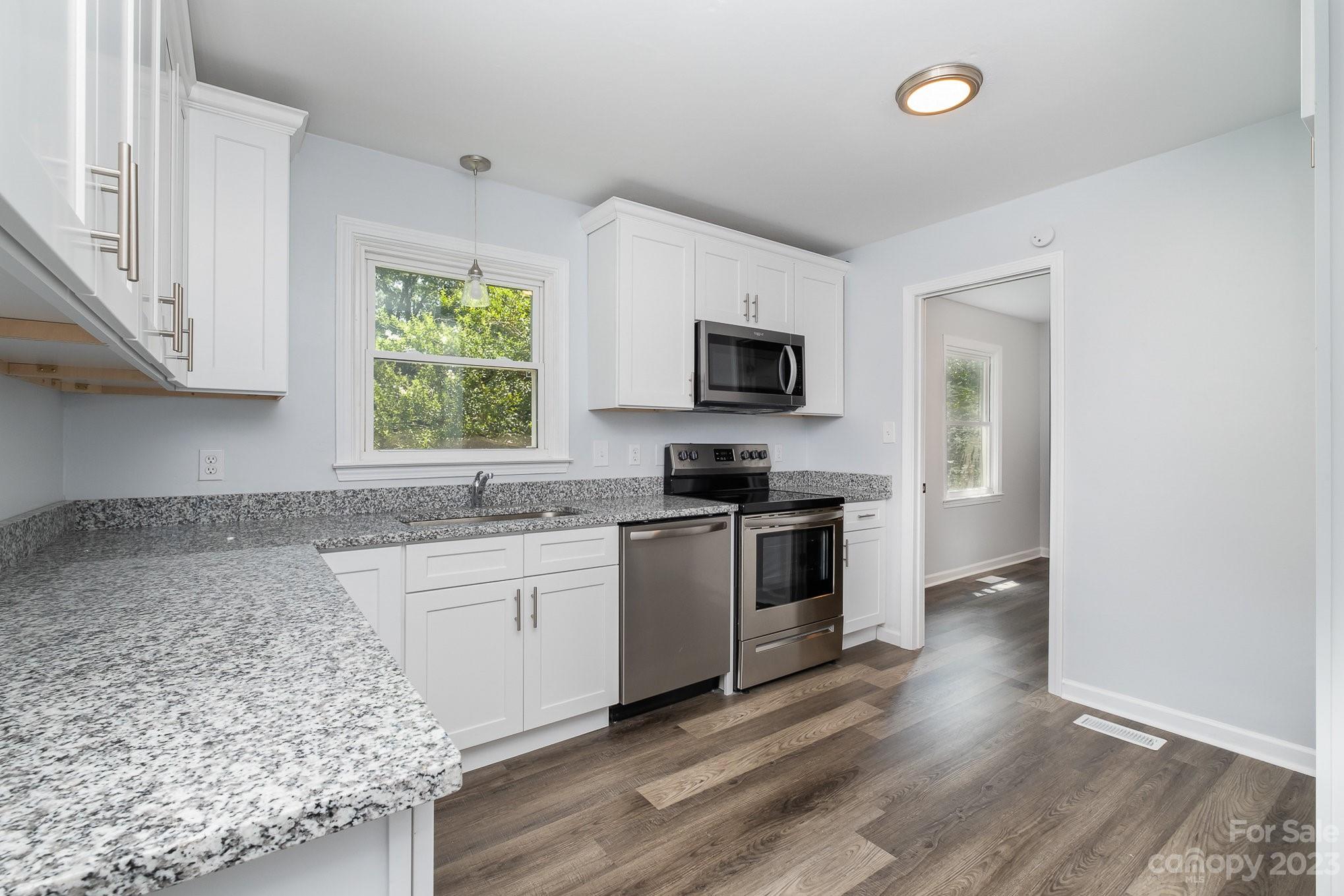 6364 Monteith Drive Charlotte, NC 28213 - Photo 15 of 35 a kitchen with a sink stove top oven and refrigerator