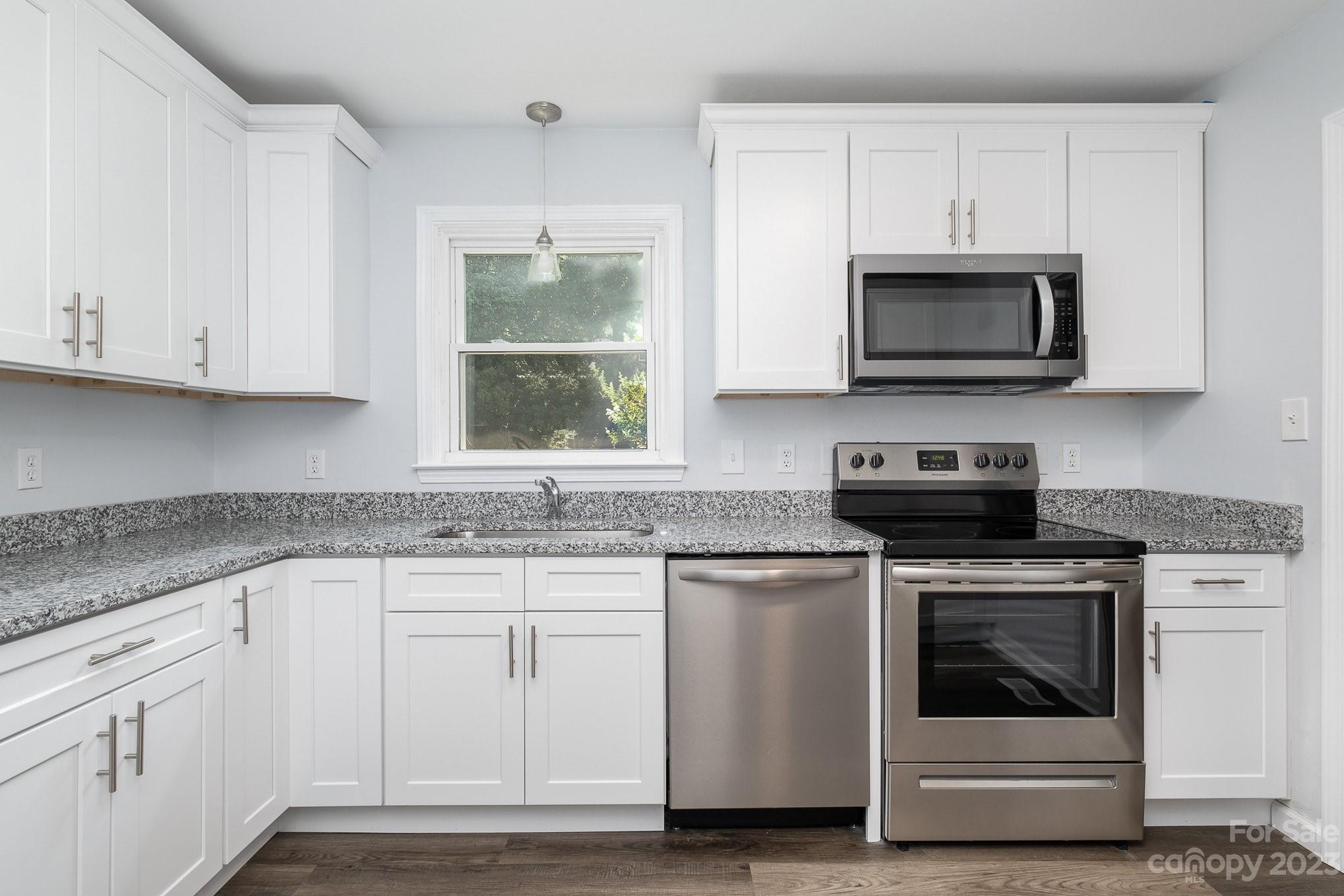6364 Monteith Drive Charlotte, NC 28213 - Photo 16 of 35 a kitchen with white cabinets and a stove top oven