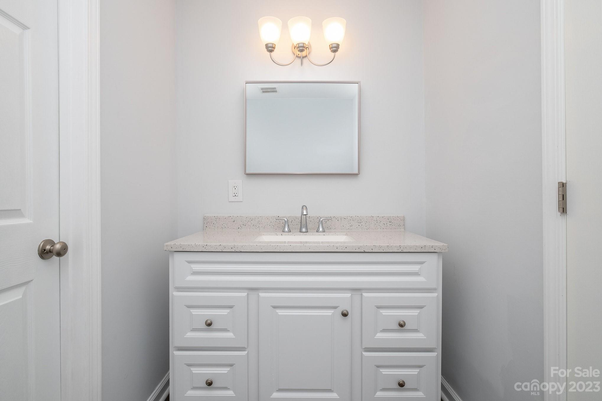 6364 Monteith Drive Charlotte, NC 28213 - Photo 29 of 35 a bathroom with a sink and a mirror