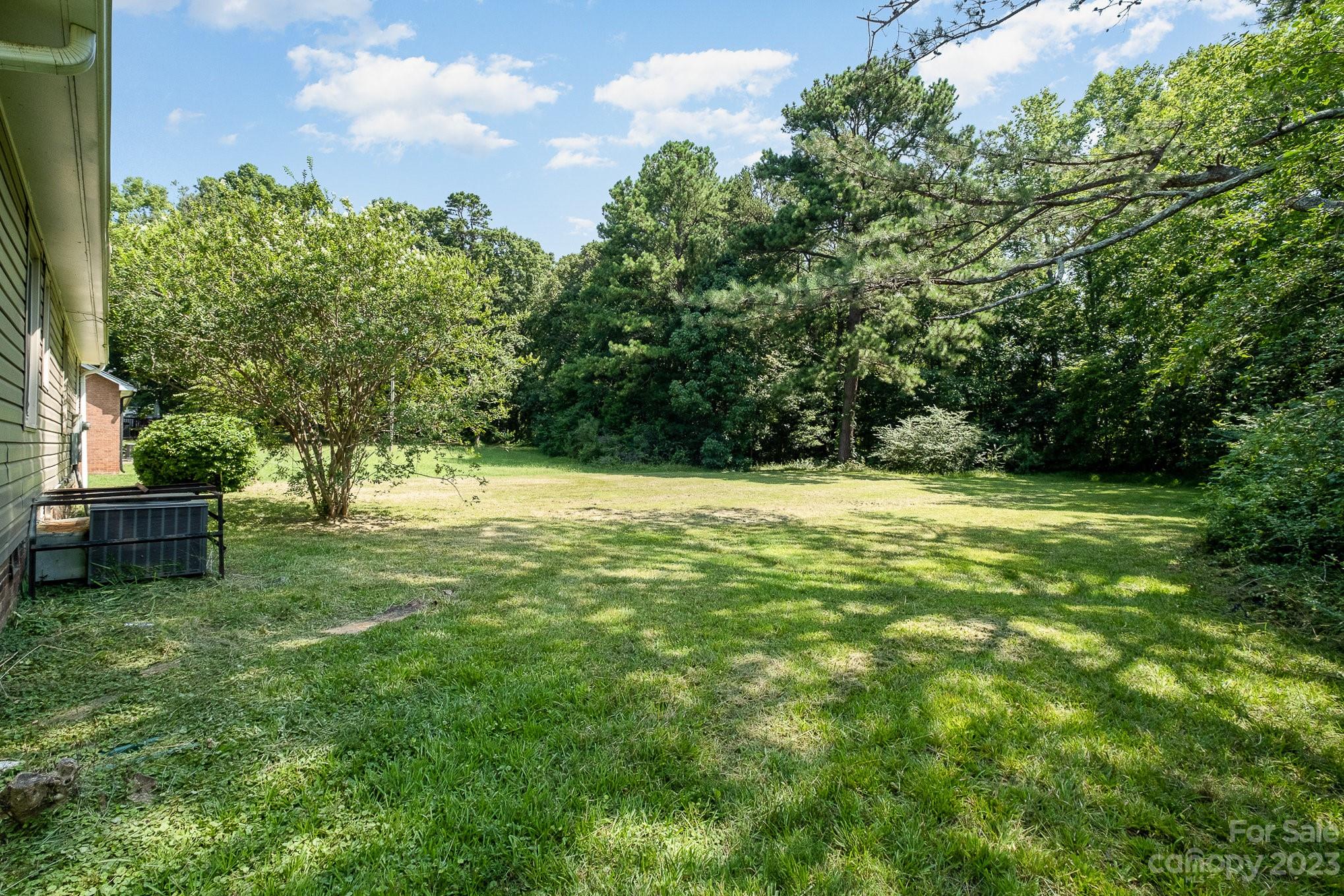 6364 Monteith Drive Charlotte, NC 28213 - Photo 32 of 35 a view of a garden with a bench