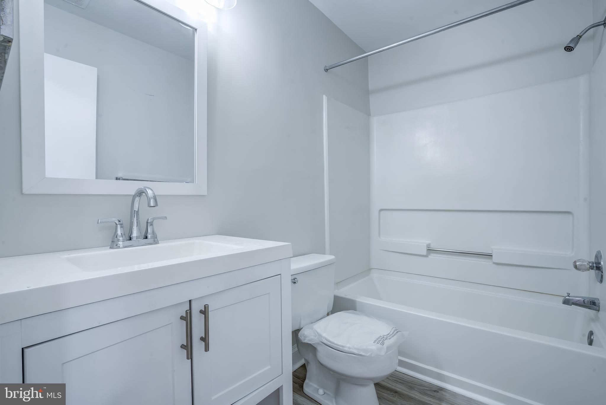 506 South Charles Street, Unit R92 Baltimore, MD 21201 - Photo 12 of 25 a bathroom with a sink a toilet and shower