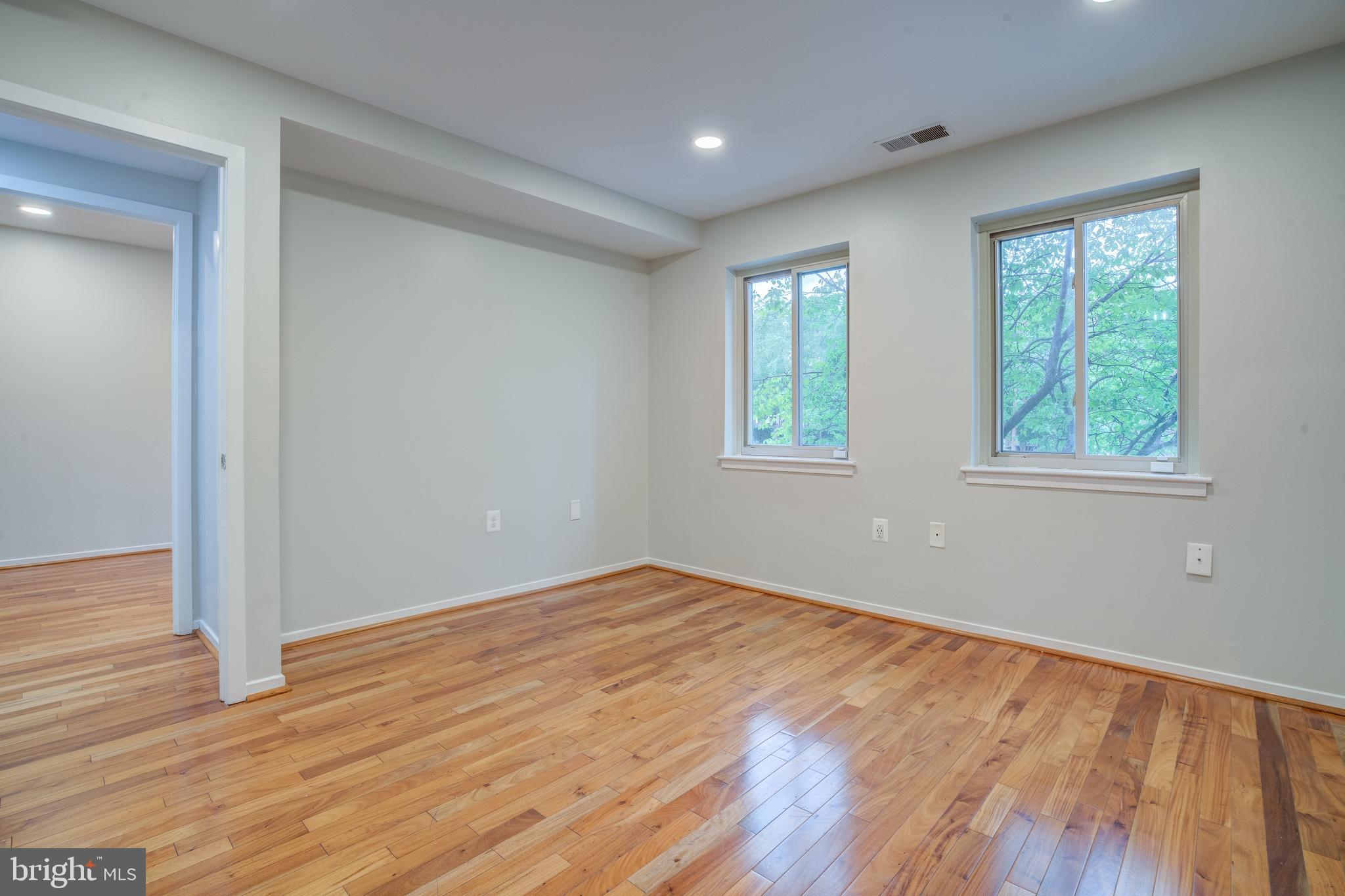 506 South Charles Street, Unit R92 Baltimore, MD 21201 - Photo 13 of 25 a view of an empty room with wooden floor and a window