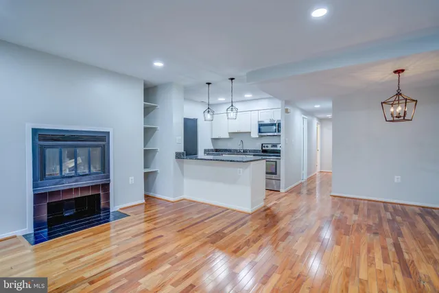 a view of kitchen with granite countertop cabinets and wooden floor