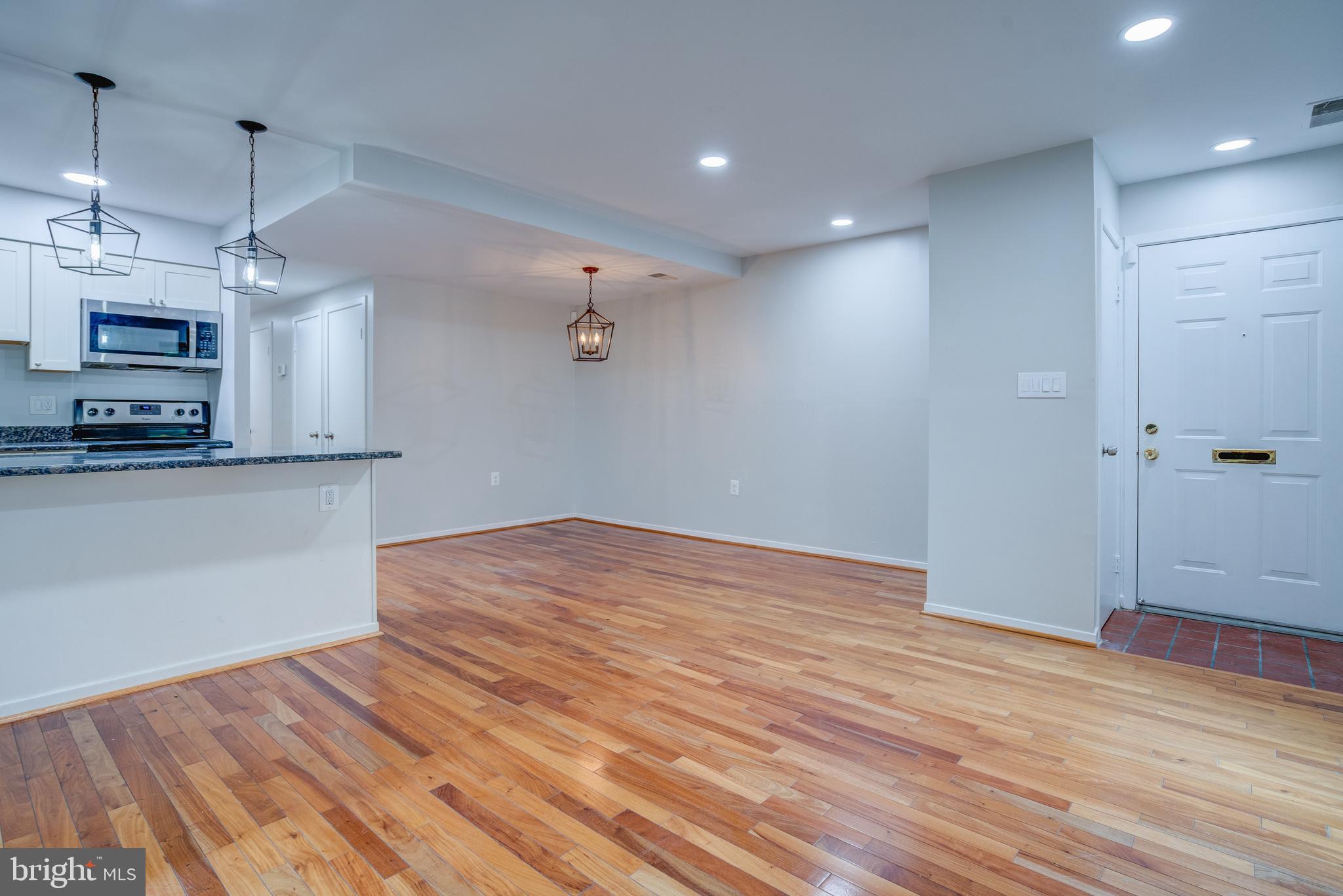 506 South Charles Street, Unit R92 Baltimore, MD 21201 - Photo 3 of 25 a view of empty room with wooden floor and ceiling fan