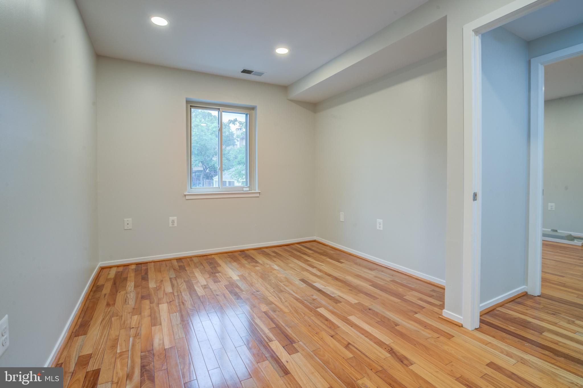 506 South Charles Street, Unit R92 Baltimore, MD 21201 - Photo 10 of 25 wooden floor in an empty room with a window