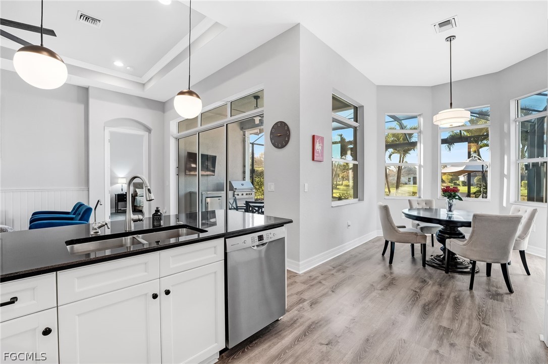 2999 Willow Ridge Court Fort Myers, FL 33905 - Photo 12 of 50 a dining room with wooden floor a chandelier a wooden table and chairs