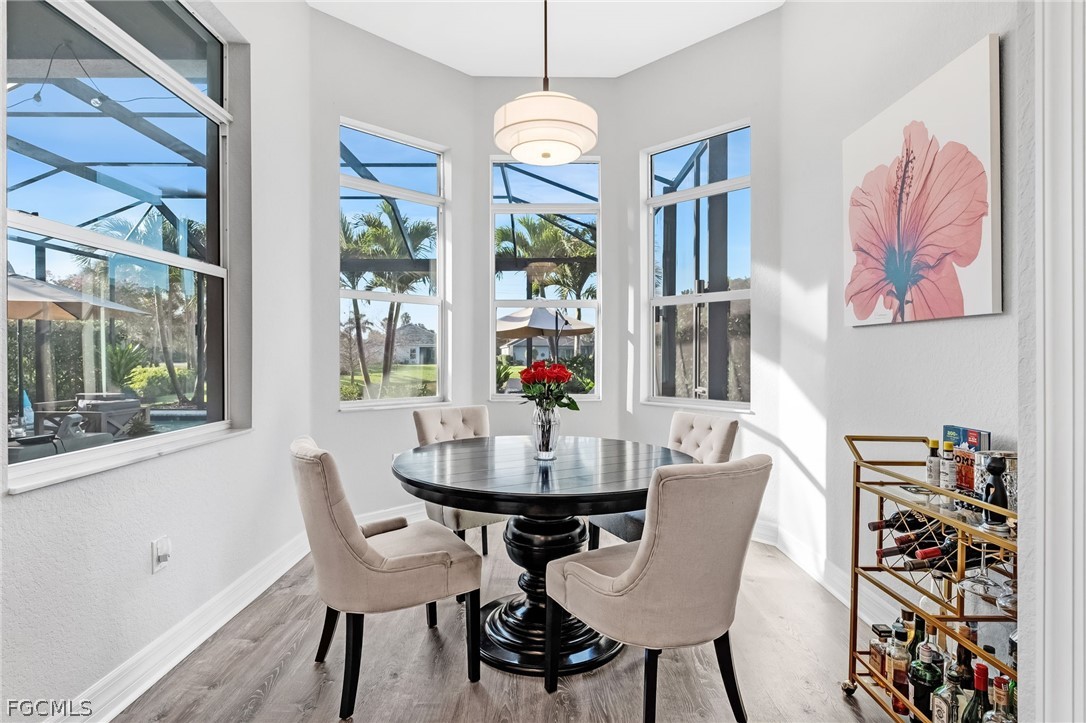 2999 Willow Ridge Court Fort Myers, FL 33905 - Photo 13 of 50 a dining room with furniture a chandelier and wooden floor
