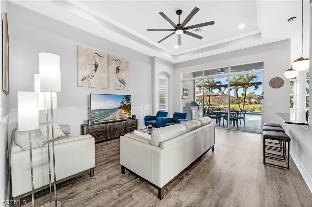 2999 Willow Ridge Court Fort Myers, FL 33905 - Photo 14 of 50 a living room with furniture a wooden floor and a chandelier