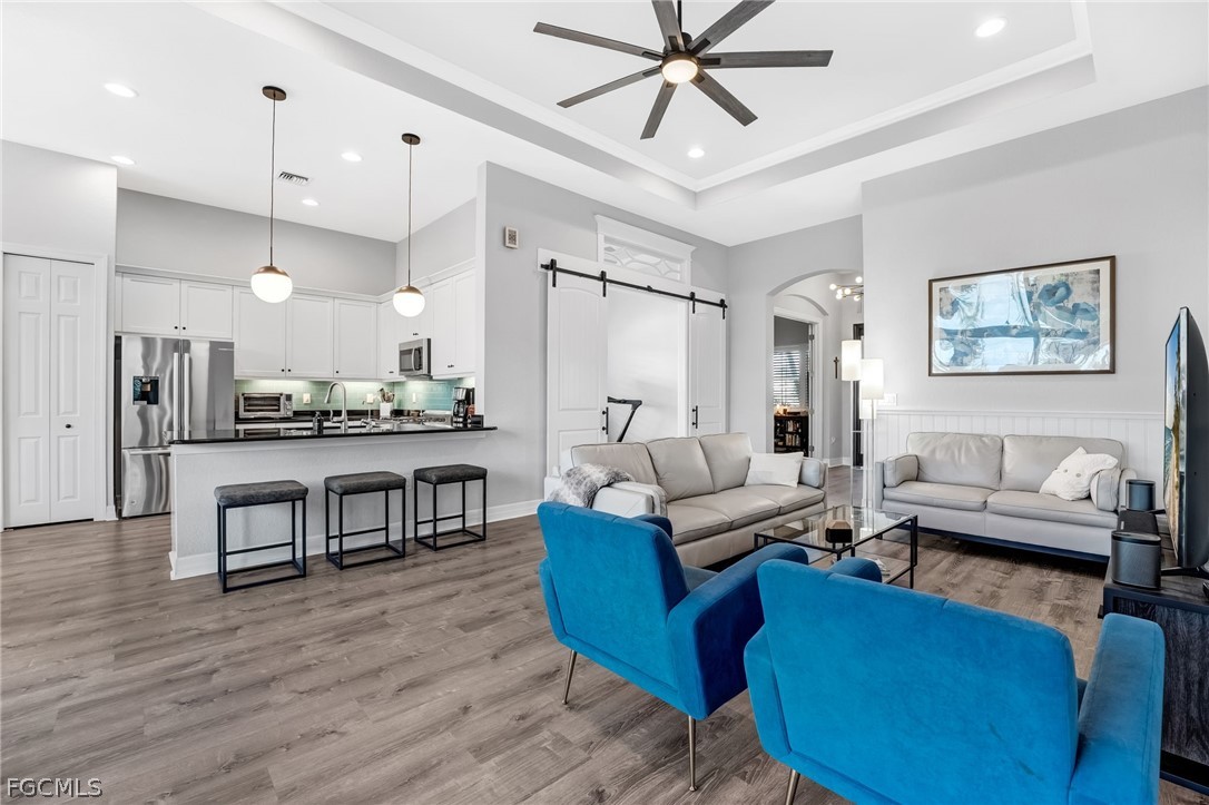 2999 Willow Ridge Court Fort Myers, FL 33905 - Photo 16 of 50 a living room with furniture kitchen view and a chandelier