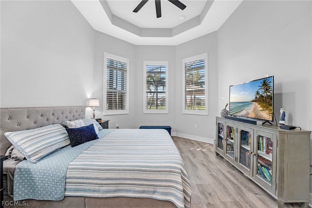2999 Willow Ridge Court Fort Myers, FL 33905 - Photo 20 of 50 a bedroom with a bed a dresser and flat screen tv