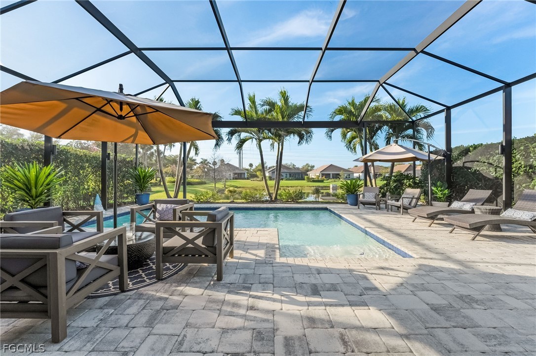 2999 Willow Ridge Court Fort Myers, FL 33905 - Photo 5 of 50 a view of patio with a table and chairs under an umbrella