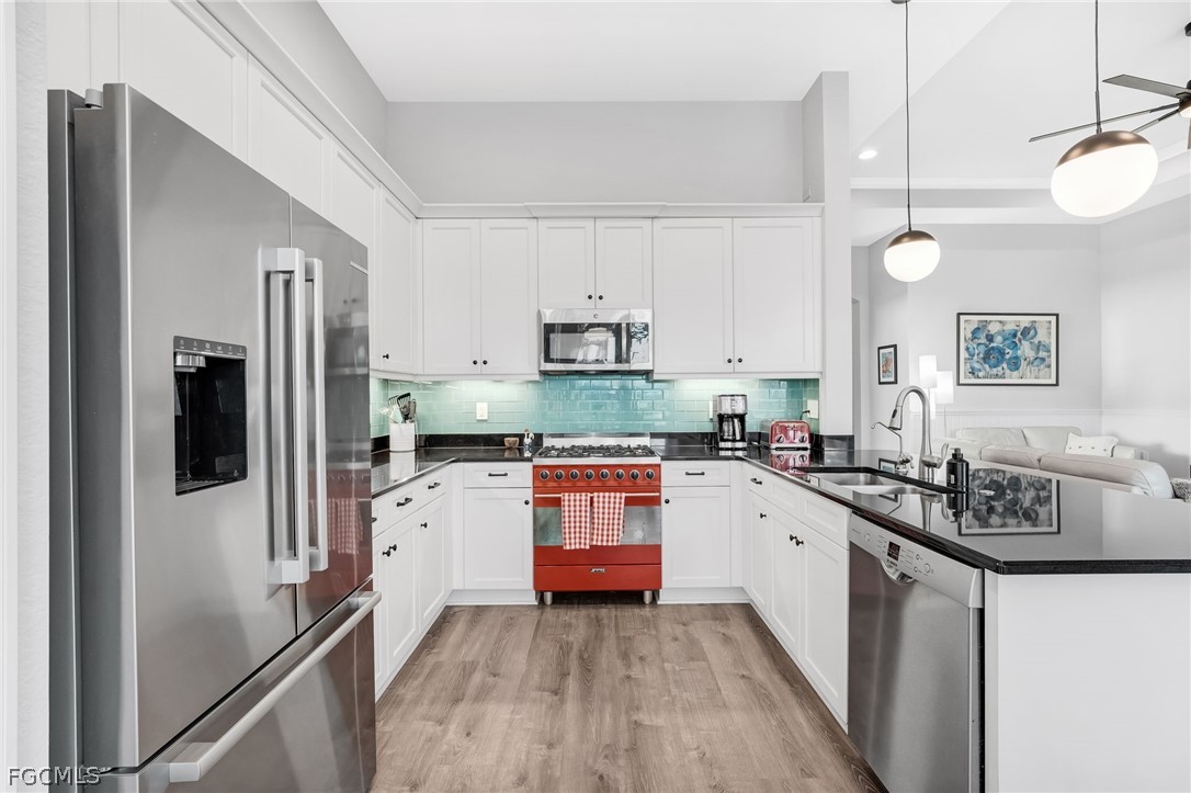 2999 Willow Ridge Court Fort Myers, FL 33905 - Photo 10 of 50 a kitchen with stainless steel appliances granite countertop a refrigerator a stove and a sink