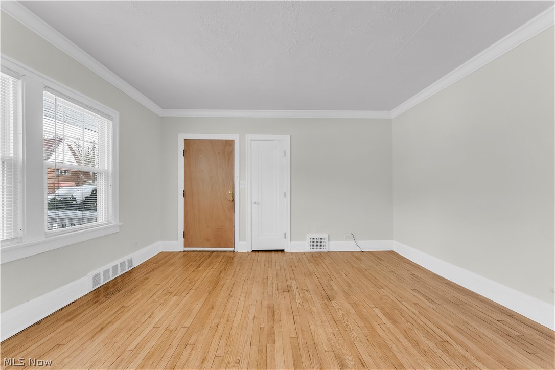 3318 Milverton Road, Unit 1/DN Shaker Heights, OH 44120 - Photo 13 of 21 Room with hardwood floors, light-colored walls, white trim, and a window with blinds