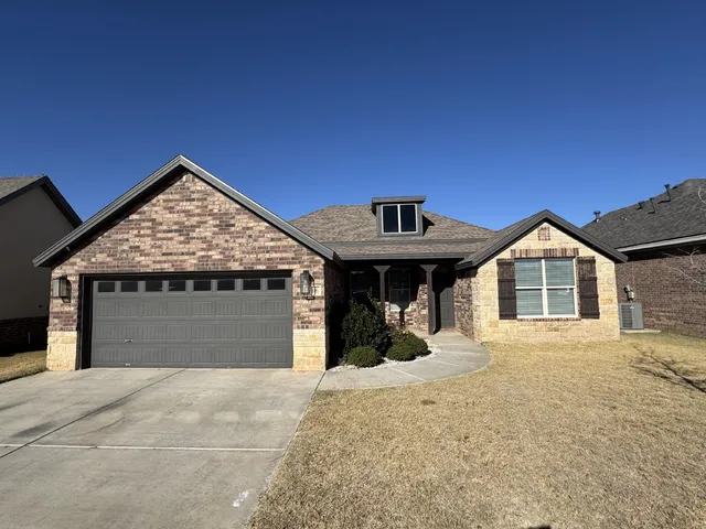 a view of a house with a yard and roof