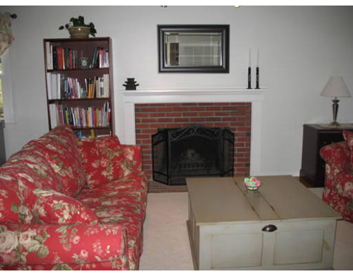 2 Parker Road Ashland, MA 01721 - Photo 29 of 29 a living room with a couch and a fireplace